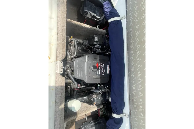 Slide: The Image of Engine compartment of a 2006 Stingray 230 LX boat, featuring a MerCruiser engine. - 12