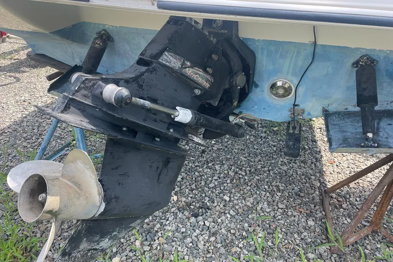 Slide: The Image of 2006 Stingray 230 LX boat stern drive and propeller on gravel surface. - 13