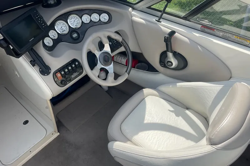 Slide: The Image of 2006 Stingray 230 LX boat cockpit with steering wheel and instrument panel. - 5