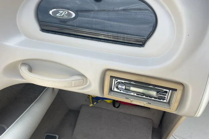 Slide: The Image of Interior of 2006 Stingray 230 LX boat with stereo system and storage compartment. - 7