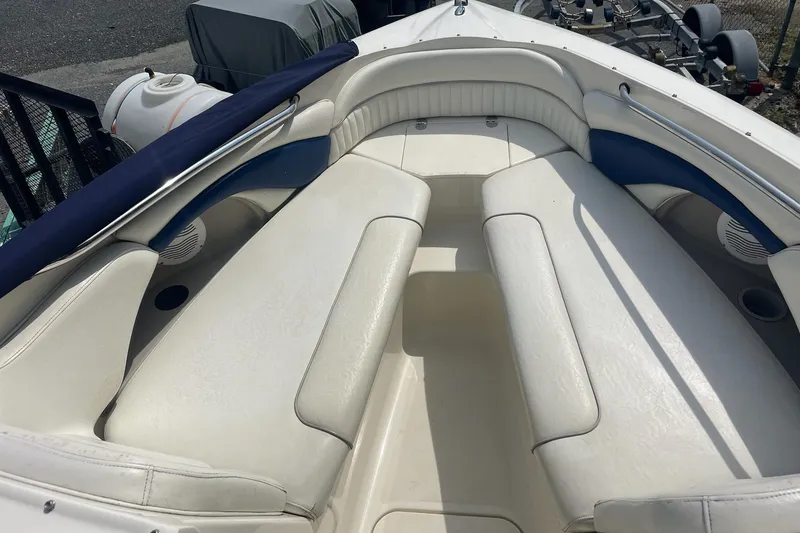 Slide: The Image of 2006 Stingray 230 LX boat interior with white cushioned seating and blue accents. - 8