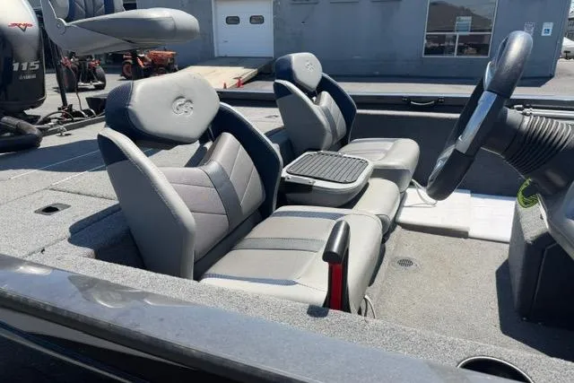 Slide: The Image of 2021 G3 Sportsman 1810 boat interior with gray seating and steering console. - 10