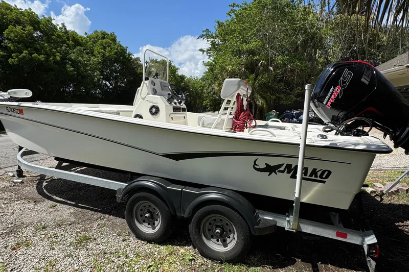 Slide: The Image of 2025 Mako Pro Skiff 19 CC boat on trailer, parked outdoors. - 12