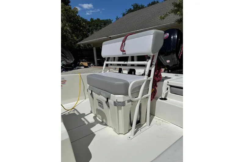 Slide: The Image of 2025 Mako Pro Skiff 19 CC boat interior with cushioned seating and storage. - 2