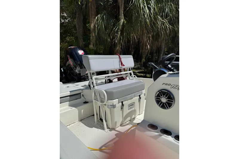 Slide: The Image of 2025 Mako Pro Skiff 19 CC boat interior with seating and steering console. - 4