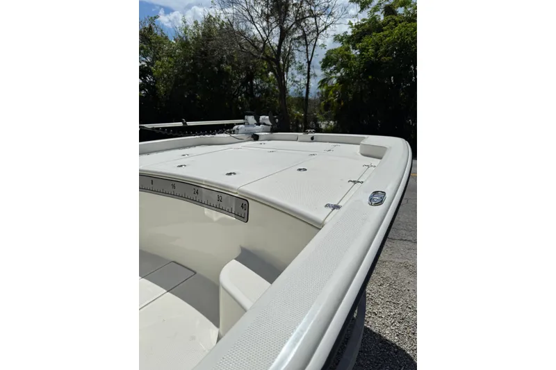 Slide: The Image of 2025 Mako Pro Skiff 19 CC boat deck with storage compartments and measuring ruler. - 5