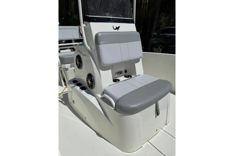 Slide: The Image of 2025 Mako Pro Skiff 19 CC boat interior with gray seating and cup holders. - 6