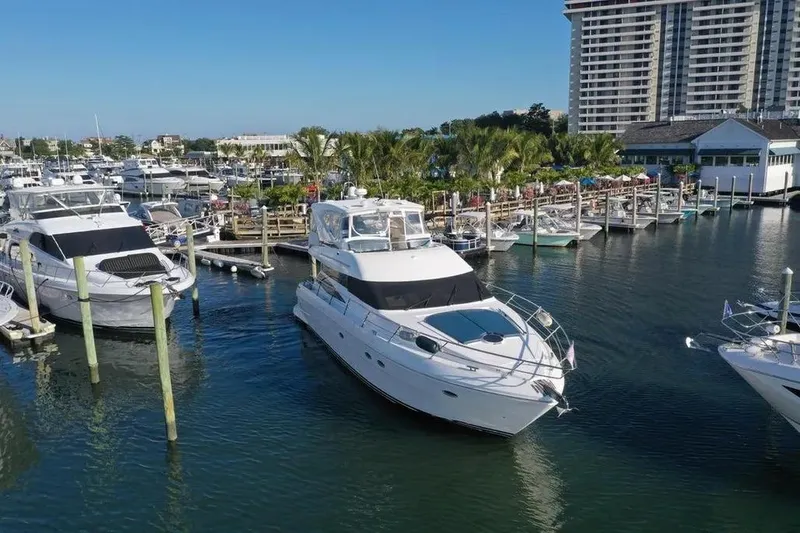 Slide: The Image of 2005 Neptunus 56 Flybridge yacht docked in a marina with surrounding boats. - 16