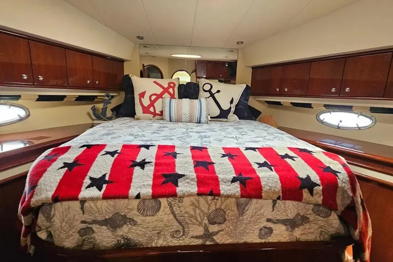 Slide: The Image of Luxurious 2005 Neptunus 56 Flybridge yacht bedroom with nautical-themed decor. - 18