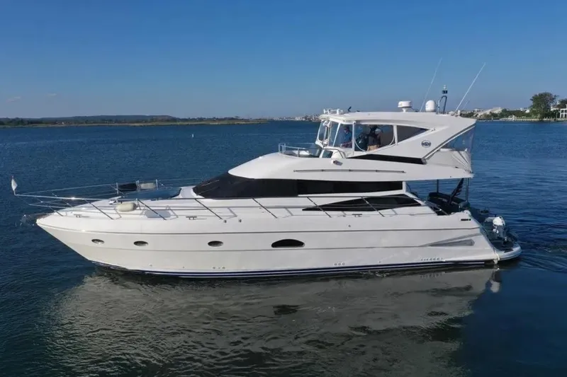 The Image of 2005 Neptunus 56 Flybridge yacht cruising on calm blue waters. - 2