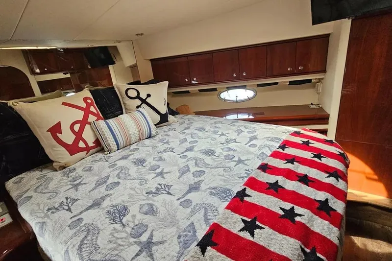 Slide: The Image of Luxurious 2005 Neptunus 56 Flybridge yacht bedroom with nautical-themed decor. - 20