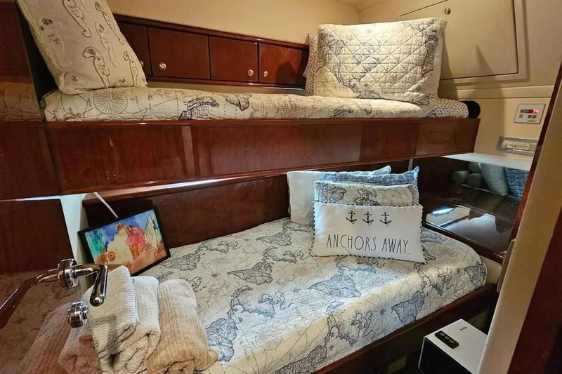 Slide: The Image of Luxurious 2005 Neptunus 56 Flybridge yacht cabin with cozy bunk beds and nautical decor. - 21