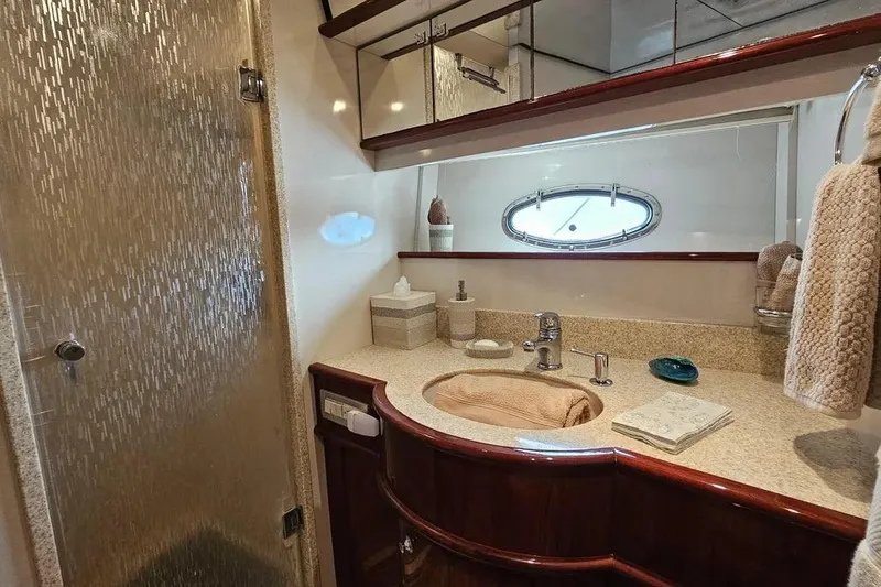 Slide: The Image of Luxurious bathroom in 2005 Neptunus 56 Flybridge yacht with elegant fixtures and porthole window. - 23