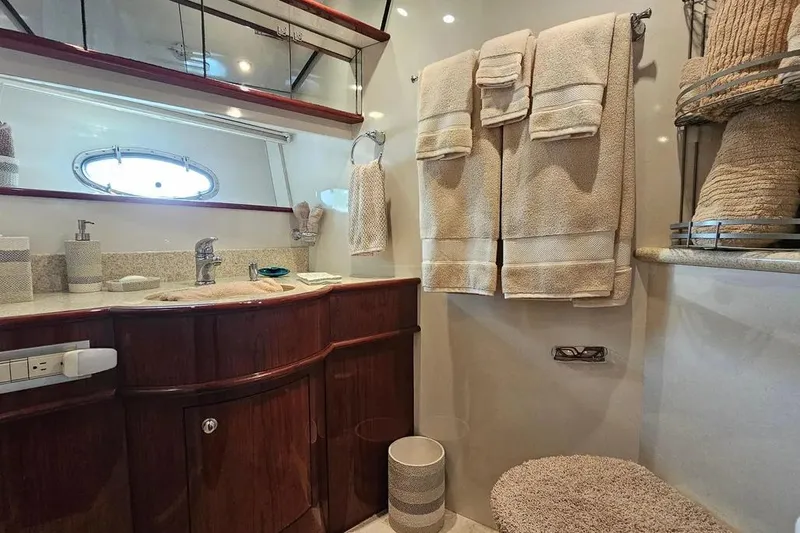 Slide: The Image of Luxurious bathroom in 2005 Neptunus 56 Flybridge yacht with elegant wood cabinetry and plush towels. - 24