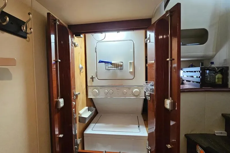 Slide: The Image of Laundry area inside 2005 Neptunus 56 Flybridge yacht with stacked washer and dryer. - 27