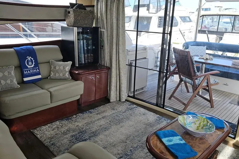 Slide: The Image of Luxurious 2005 Neptunus 56 Flybridge yacht interior with elegant seating and marina view. - 31