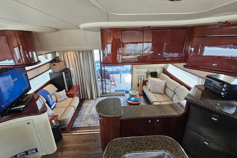 Slide: The Image of Luxurious interior of 2005 Neptunus 56 Flybridge yacht with elegant seating and modern amenities. - 34