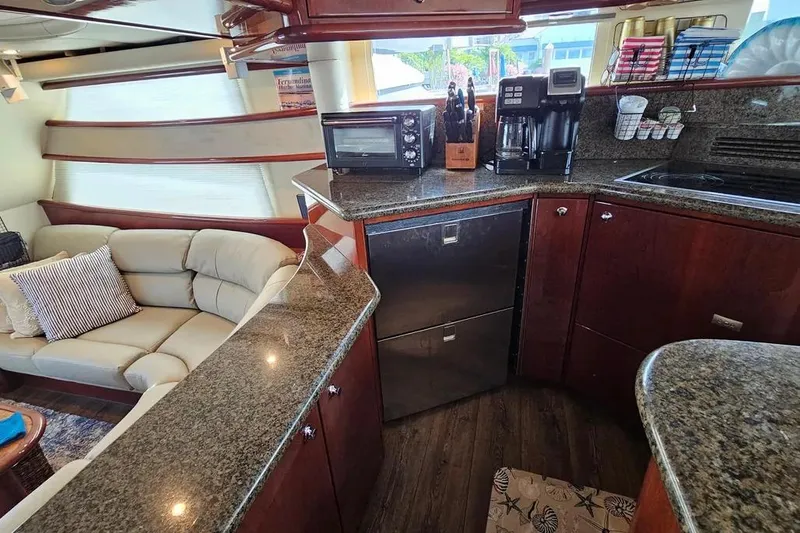 Slide: The Image of Luxurious 2005 Neptunus 56 Flybridge yacht interior with modern kitchen and cozy seating area. - 35