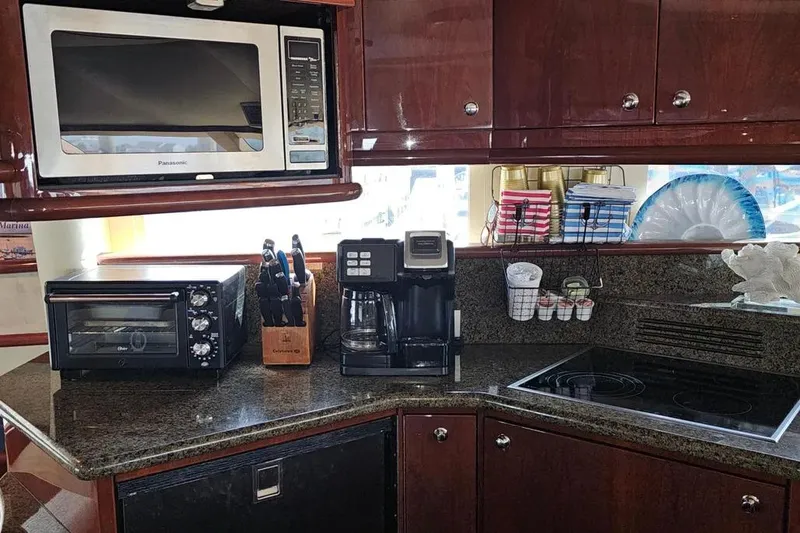 Slide: The Image of Luxurious 2005 Neptunus 56 Flybridge yacht kitchen with modern appliances and elegant cabinetry. - 36