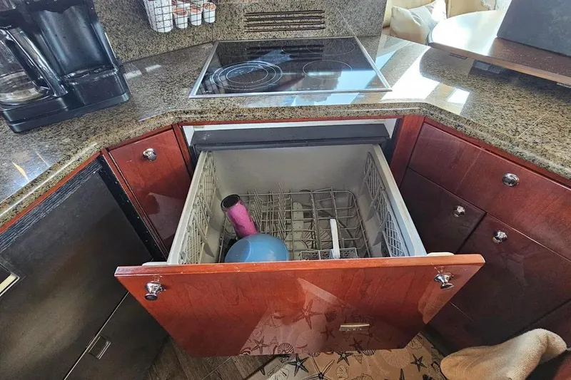Slide: The Image of Kitchen area of a 2005 Neptunus 56 Flybridge yacht with open dishwasher. - 37