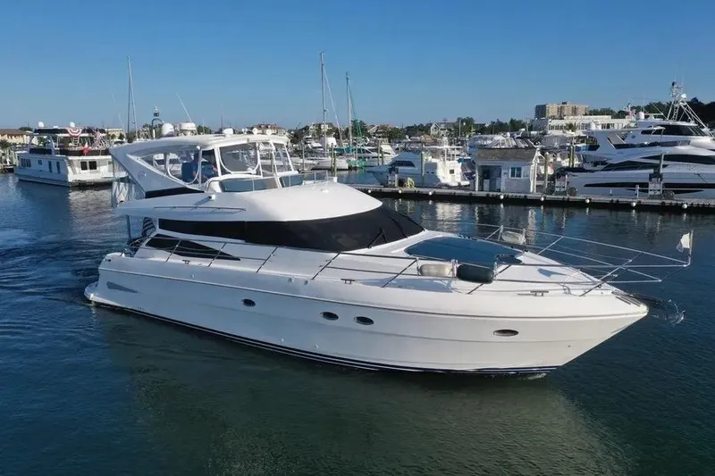Slide: The Image of 2005 Neptunus 56 Flybridge yacht docked in a marina under clear blue skies. - 4
