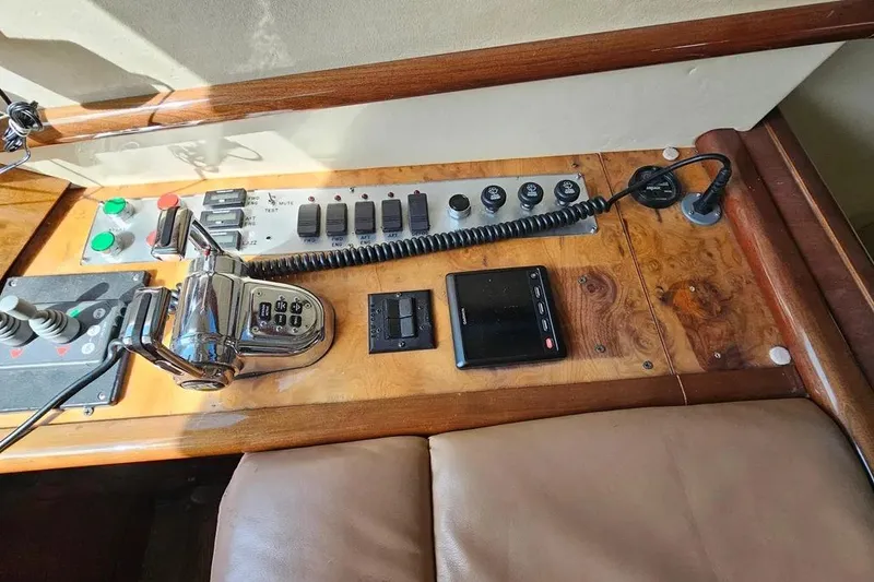 Slide: The Image of Control panel of a 2005 Neptunus 56 Flybridge yacht with various switches and controls. - 45