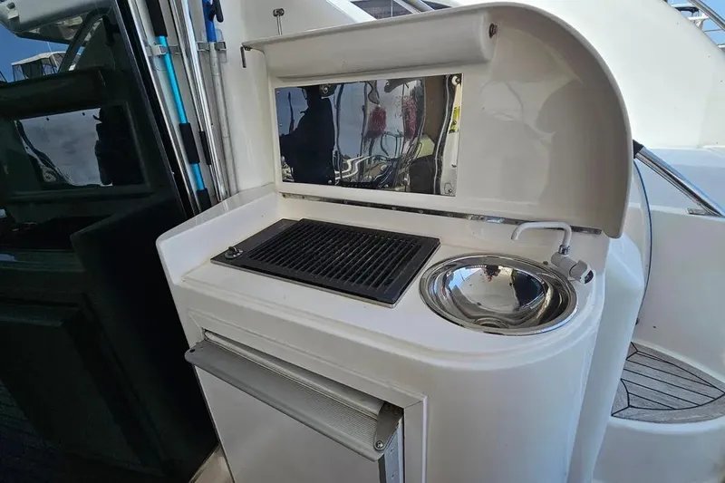 Slide: The Image of Outdoor kitchenette on 2005 Neptunus 56 Flybridge yacht with grill and sink. - 47