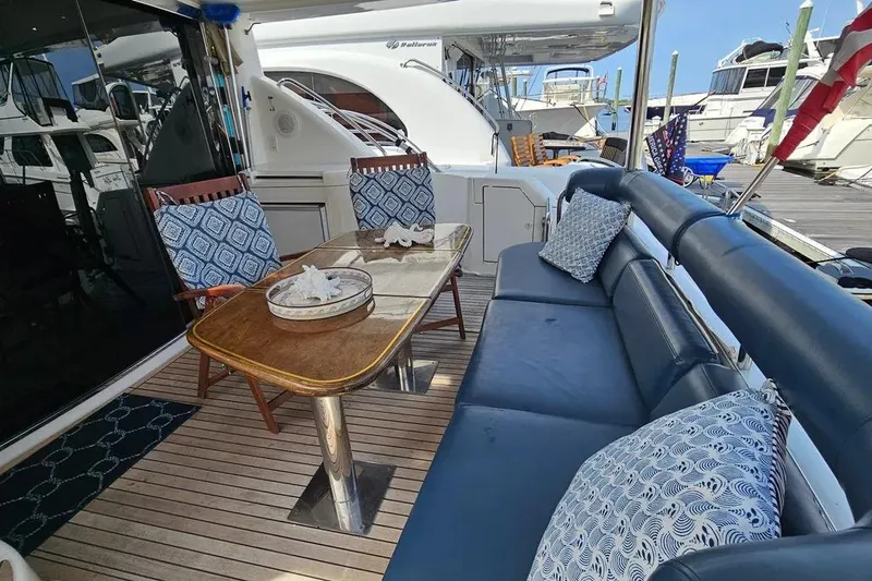 Slide: The Image of Luxurious 2005 Neptunus 56 Flybridge yacht deck with elegant seating and table. - 48