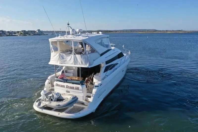 Slide: The Image of 2005 Neptunus 56 Flybridge yacht cruising on open water, rear view. - 5
