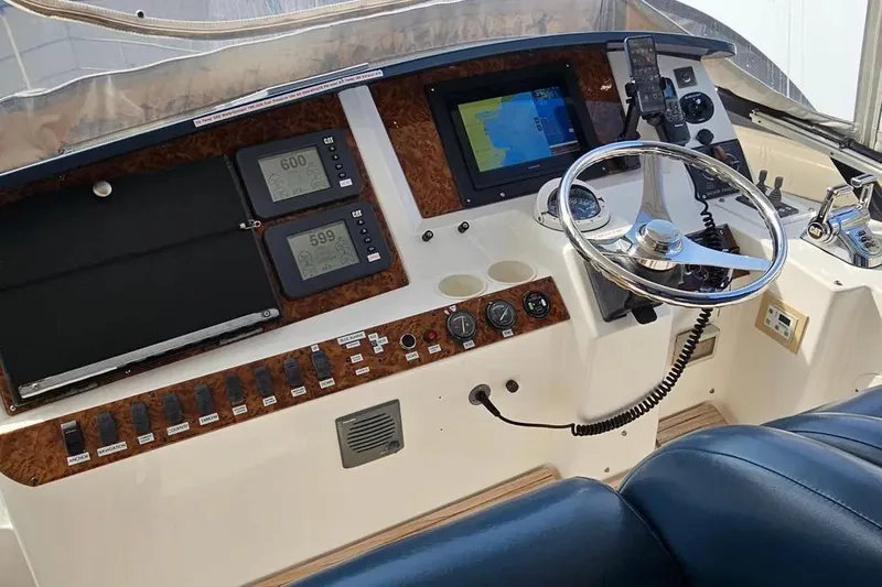 Slide: The Image of Helm of 2005 Neptunus 56 Flybridge yacht with navigation instruments and steering wheel. - 50