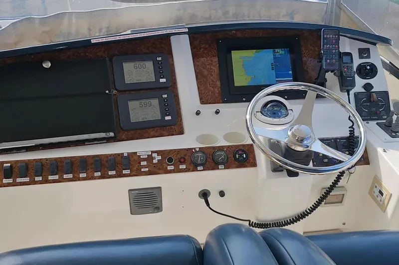 Slide: The Image of Helm of 2005 Neptunus 56 Flybridge yacht with navigation instruments and steering wheel. - 51