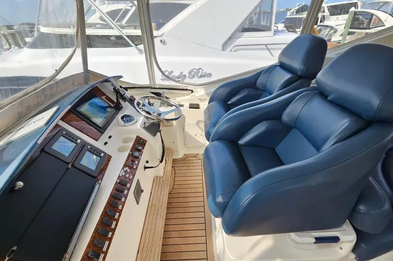 Slide: The Image of Luxurious 2005 Neptunus 56 Flybridge helm with blue leather seats and advanced controls. - 53