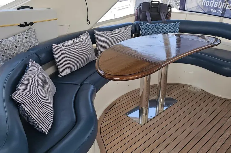 Slide: The Image of Luxurious 2005 Neptunus 56 Flybridge yacht interior with elegant seating and polished wood table. - 54