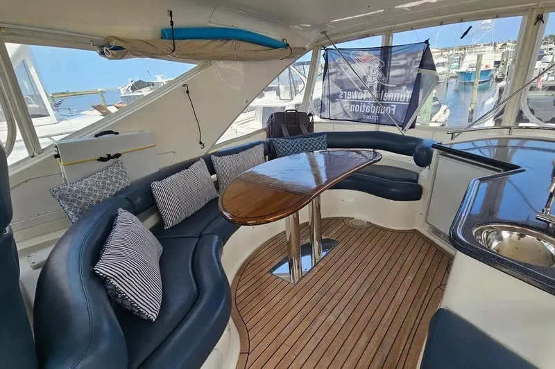 Slide: The Image of Luxurious 2005 Neptunus 56 Flybridge yacht interior with elegant seating and wooden table. - 55