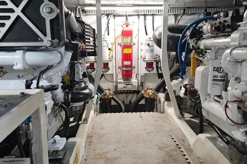 Slide: The Image of Engine room of 2005 Neptunus 56 Flybridge yacht, featuring CAT machinery and fire safety equipment. - 61