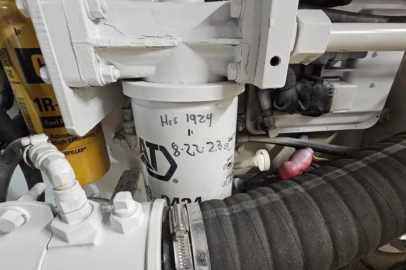 Slide: The Image of Engine compartment of 2005 Neptunus 56 Flybridge with visible fuel filter and hoses. - 64