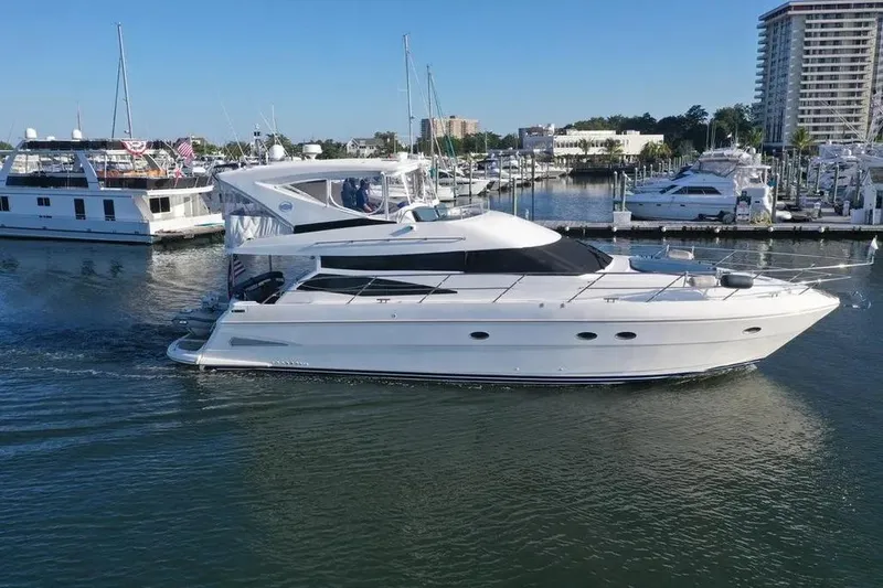 Slide: The Image of 2005 Neptunus 56 Flybridge yacht cruising in a marina with other boats nearby. - 7