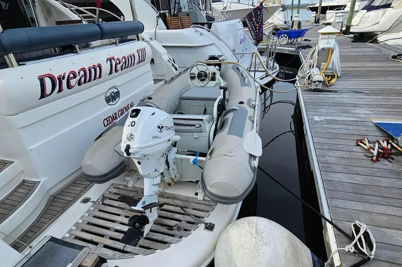 Slide: The Image of Docked Neptunus 56 Flybridge yacht with inflatable boat and Tohatsu outboard motor. - 75
