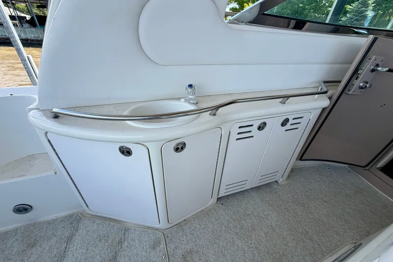 Slide: The Image of 2001 Sea Ray 410 Sundancer yacht interior with sink and storage cabinets. - 10