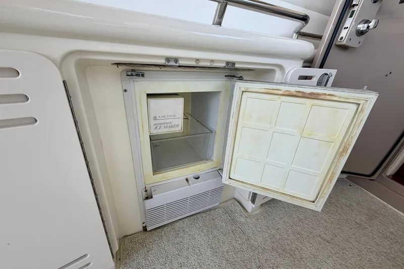 Slide: The Image of 2001 Sea Ray 410 Sundancer boat ice maker with open door, showing interior. - 11