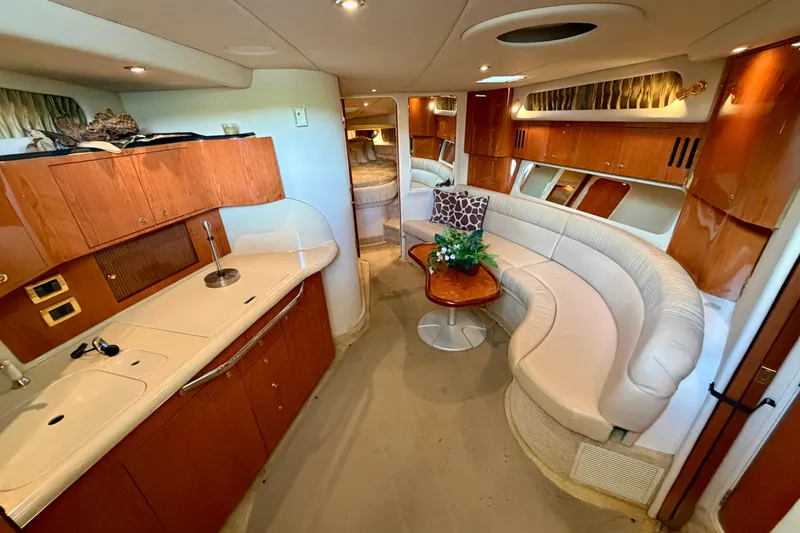 Slide: The Image of Luxurious interior of a 2001 Sea Ray 410 Sundancer yacht with elegant seating and cabinetry. - 12