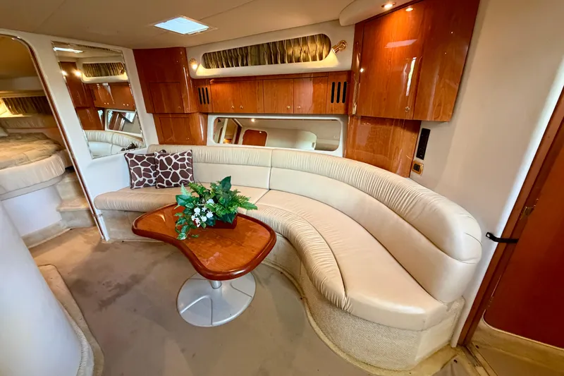 Slide: The Image of Luxurious interior of 2001 Sea Ray 410 Sundancer with elegant seating and wooden cabinetry. - 13