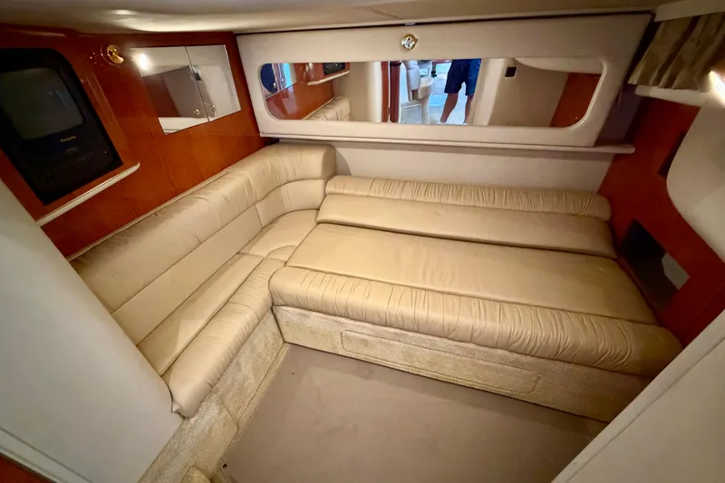 Slide: The Image of Luxurious interior of 2001 Sea Ray 410 Sundancer with beige seating and wood accents. - 15