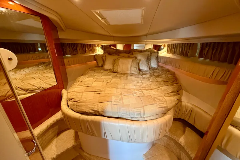 Slide: The Image of Luxurious cabin interior of a 2001 Sea Ray 410 Sundancer yacht with plush bedding. - 17