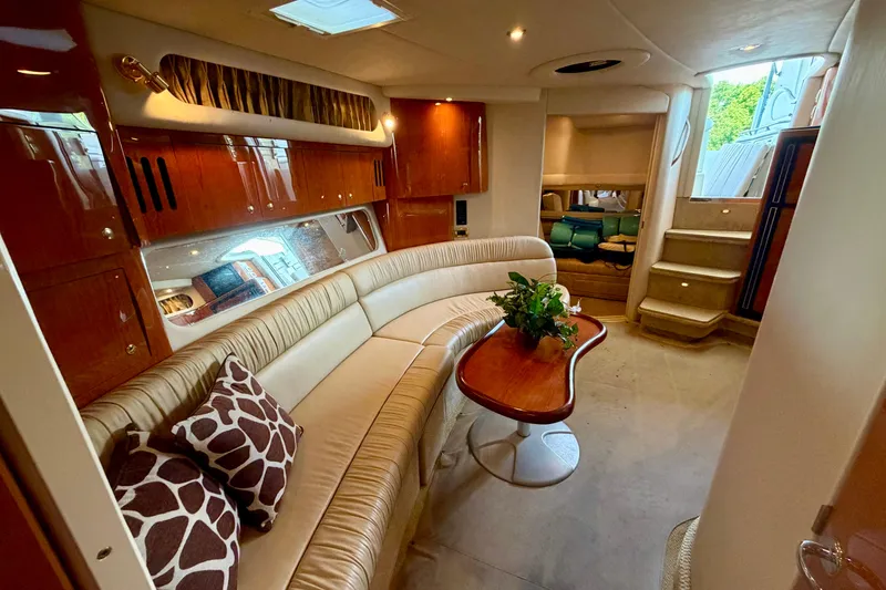 Slide: The Image of Luxurious interior of 2001 Sea Ray 410 Sundancer yacht with elegant seating and wooden accents. - 19