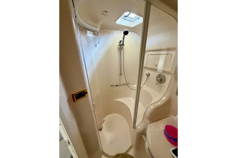 Slide: The Image of Compact bathroom in a 2001 Sea Ray 410 Sundancer yacht with shower and skylight. - 22