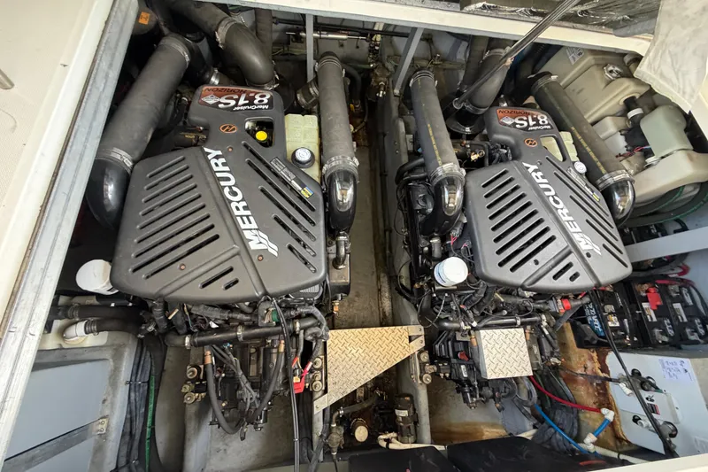 Slide: The Image of Engine compartment of a 2001 Sea Ray 410 Sundancer with twin Mercury engines. - 24