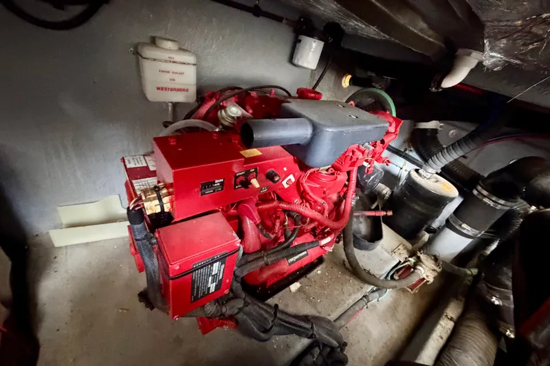 Slide: The Image of Engine room of a 2001 Sea Ray 410 Sundancer with red machinery and wiring. - 25