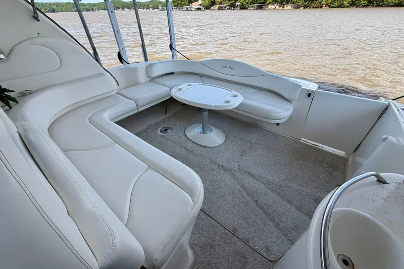 Slide: The Image of Spacious seating area on a 2001 Sea Ray 410 Sundancer yacht, overlooking a scenic waterway. - 3