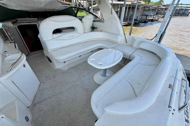 Slide: The Image of 2001 Sea Ray 410 Sundancer boat interior with white seating and table. - 4